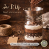 Homemade brownie mix being poured into a glass jar for pantry storage