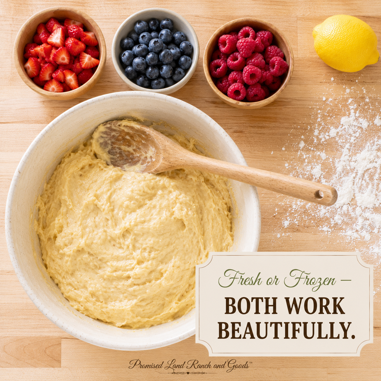Overhead view of a white ceramic mixing bowl with quick bread batter surrounded by small prep bowls of fresh strawberries, blueberries, and raspberries on a wood counter, ready to fold into mixed berry bread.